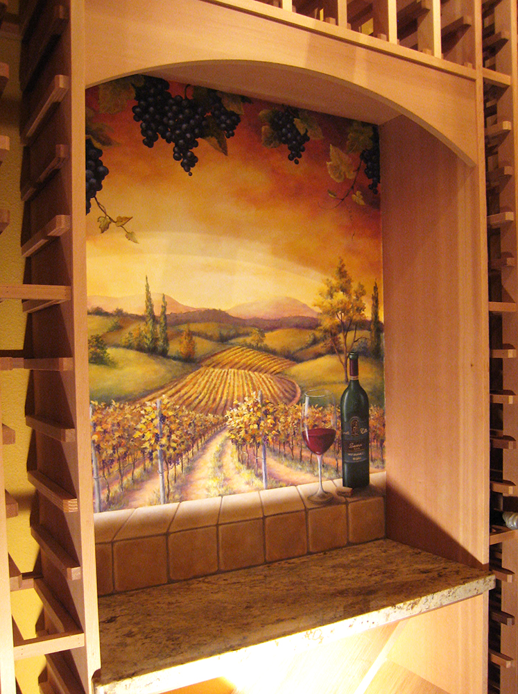 Acrylic paints were used to paint a sunset-lit sky beaming on a vineyard landscape in this wine cellar mural. The client’s favorite bottle of wine was added as a final, personal touch.