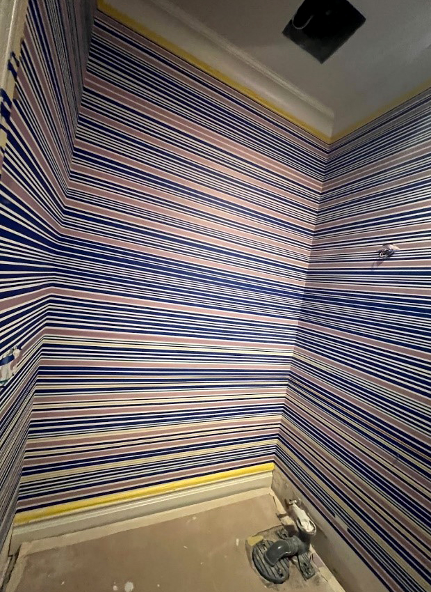 The linear plaster bathroom in process - All the purple and blue lines on the walls are tape! (Anna Reduce - Dorato Designs)
