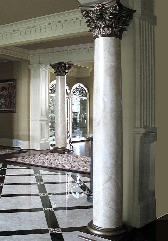 These columns are an integral part of the design of this foyer. kasswilson.com/is-it-real-faux-marbled-columns/