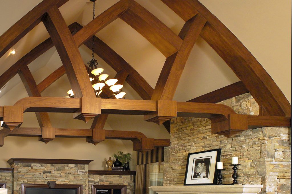These intricate beams follow the curves of the arched ceiling. Their graceful shape and interesting architecture is possible because they were constructed out of fiber board and painted to match the wood cabinets!  https://kasswilson.com/high-expectations/