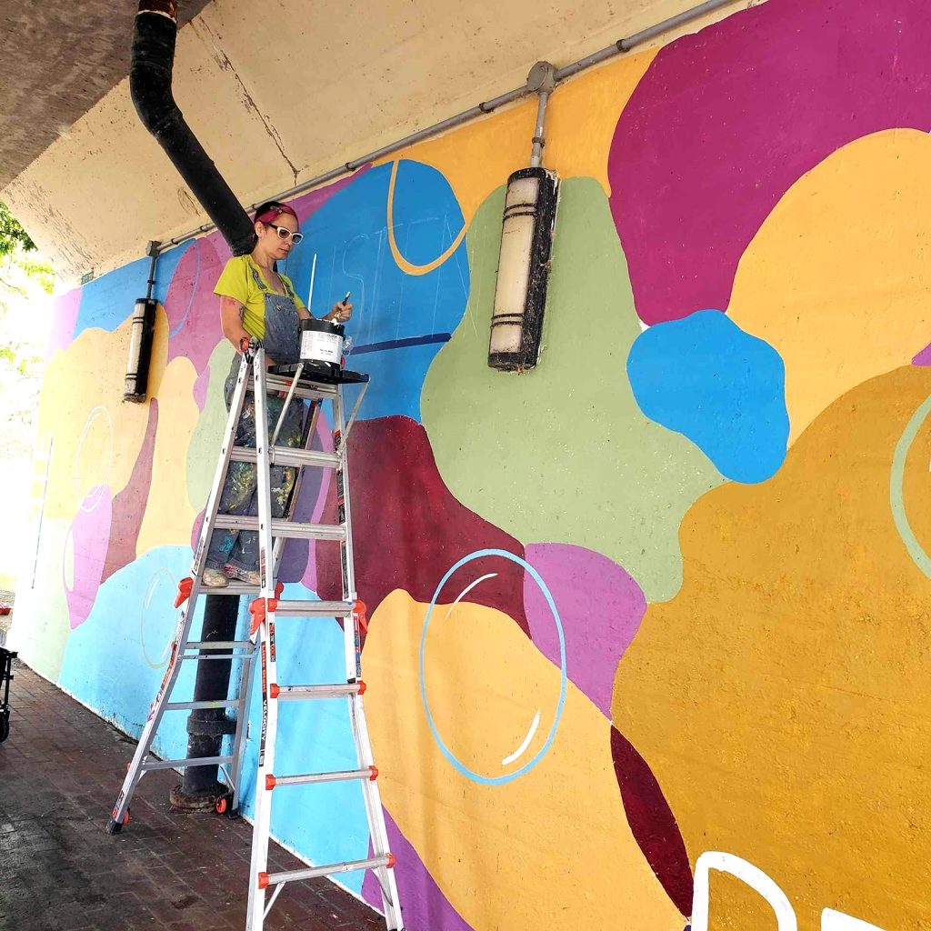 “Read, Write, Listen” work in progress. This is a backdrop for a community space including a little library with free writing and journaling supplies.